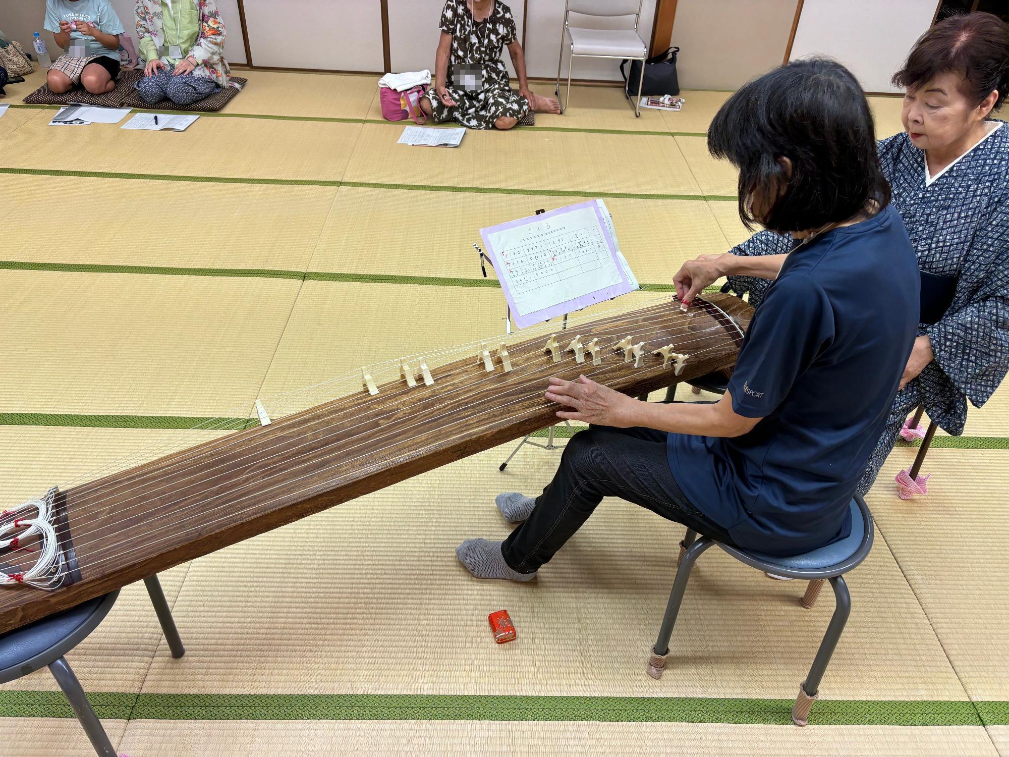 お琴の演奏を体験する参加者