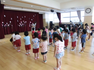体育館で整列しているふじ組、ばら組、もも組の子供たちの写真