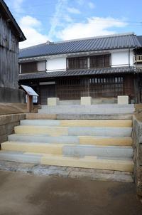 石段を上がった奥に工楽松右衛門旧宅がある様子の写真