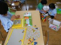 高砂児童学園内の教室でジグソーパズルやブロックなどで遊ぶ園児たちの写真